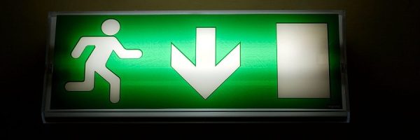 bigstock-Emergency-exit-sign-glowing-gr-26295572-900x563