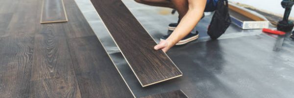 laminate flooring - worker installing new floor