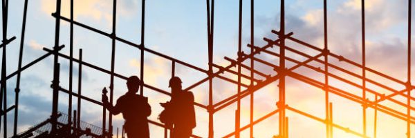 construction worker on construction site at sunset